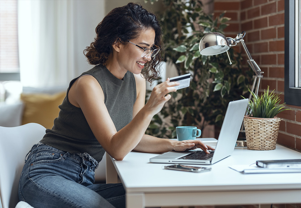 woman at laptop with debit card