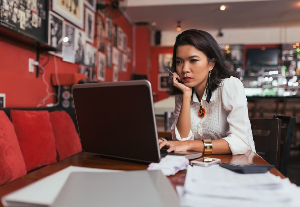 female business owner looking at her laptop in her small business